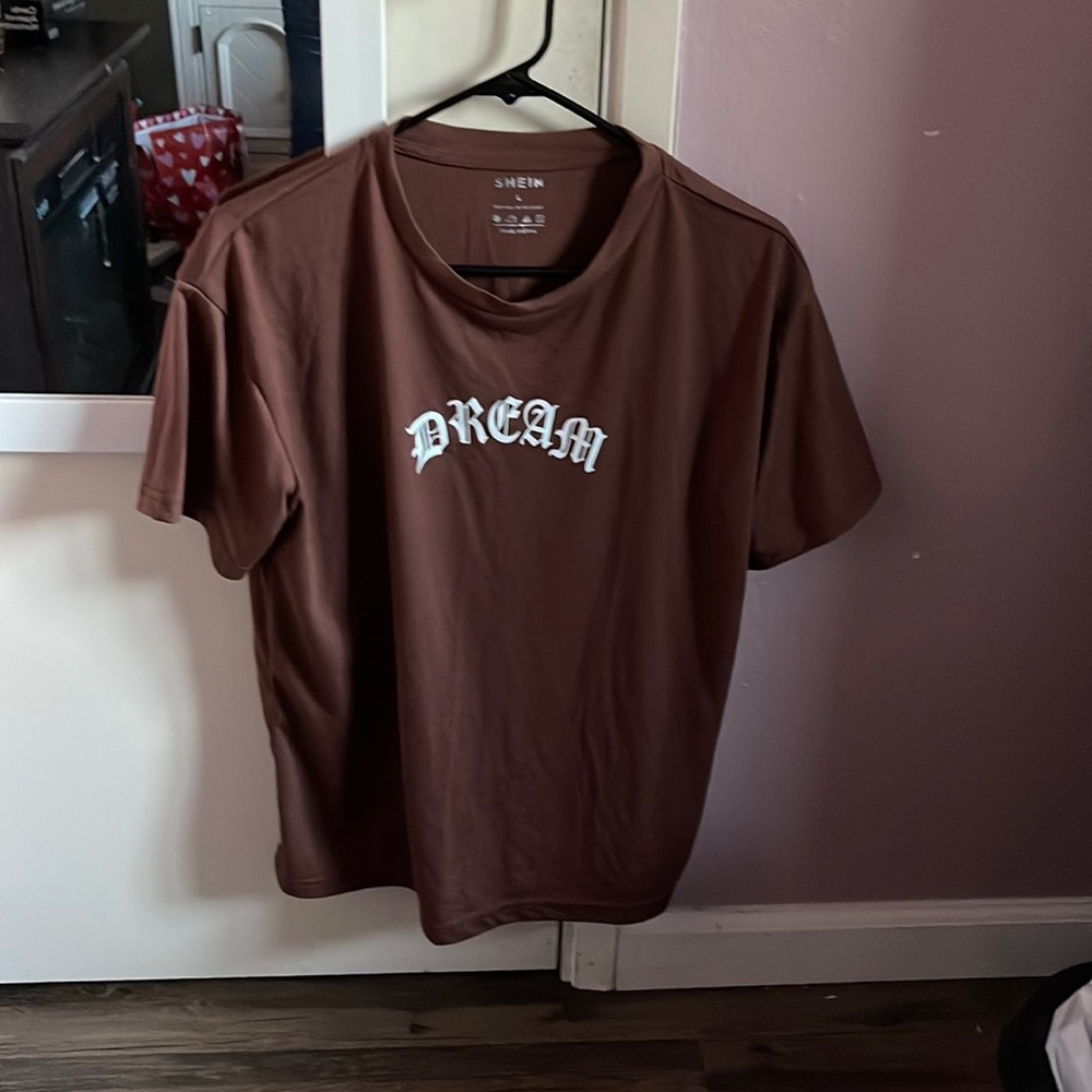 Brown T-shirt that says “dream” with a butterfly on the back